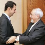 Syria's President Bashar al-Assad welcomes Iran's Foreign Minister Mohammad Javad Zarif, before a meeting in Damascus