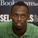 Jamaican athlete Usain Bolt poses for photographers as he signs copies of his autobiography, "Faster than Lightning," at Selfridges in central London
