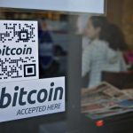 File photo of signs on window advertise bitcoin ATM machine in Vancouver