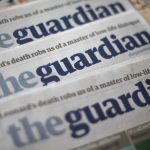 Copies of the Guardian newspaper are displayed at a news agent in London