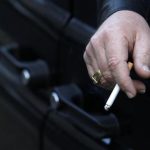 A man smokes in his car in London