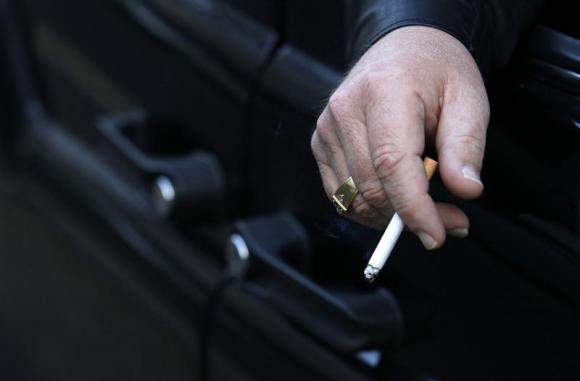 A man smokes in his car in London