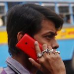 A man uses a Nokia mobile phone to make a call on a street in Kolkata