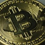 A mock Bitcoin is displayed on a table in an illustration picture taken in Berlin