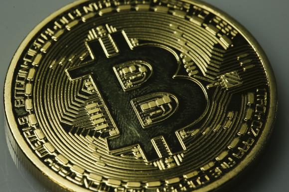 A mock Bitcoin is displayed on a table in an illustration picture taken in Berlin