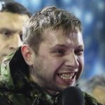 Anti-presidential protester Parasiuk addresses the crowd as opposition leader Klitschko looks on during a rally in Kiev