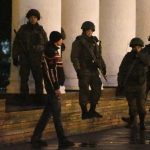 Armed men stand guard at the airport in Simferopol