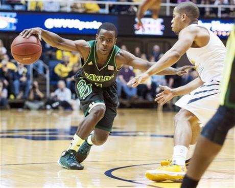 Baylor's Kenny Chery, left, drives by West Virginia's Gary Browne