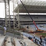 An official from Brazil's World Cup organizers accompanies visitors on a tour inside the Arena Pantanal soccer stadium in Cuiaba