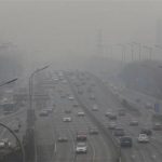 Cars drive on the second ring road amid the heavy haze in Beijing