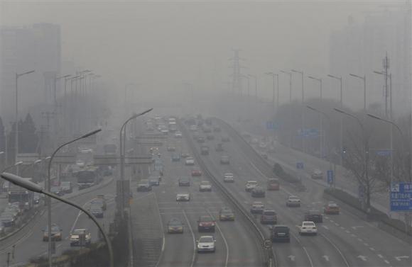 Cars drive on the second ring road amid the heavy haze in Beijing