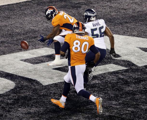 Denver Broncos' Knowshon Moreno (27) , Seattle Seahawks' Heath Farwell (55), teammate Julius Thomas (80)