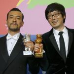 Actor Liao Fan and director Diao Yinan pose with Silver Bear for Best Actor and Golden Bear for Best film after awards ceremony of 64th Berlinale International Film Festival in Berlin