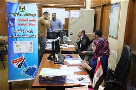 Election officials prepare to distribute voter ID cards to Iraqi citizens in Baghdad