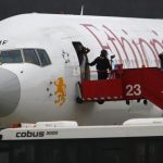 Police officers help passengers disembark from the hijacked Ethiopian Airlines flight ET 702 at Cointrin Airport in Geneva