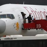 Police officers help passengers disembark from the hijacked Ethiopian Airlines flight ET 702 at Cointrin Airport in Geneva