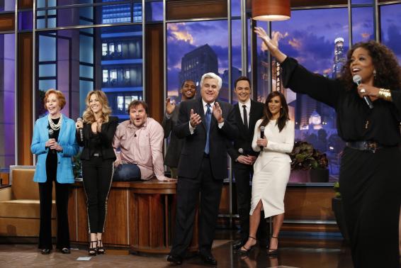 Jay Leno listens to Oprah Winfrey sing on his final night hosting "The Tonight Show with Jay Leno" in Burbank, California
