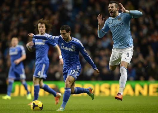 Manchester City's Negredo is challenged by Chelsea's Hazard during their English Premier League soccer match at the Etihad Stadium in Manchester