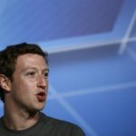 Facebook CEO Zuckerberg smiles in the stage before delivering a keynote speech during the Mobile World Congress in Barcelona