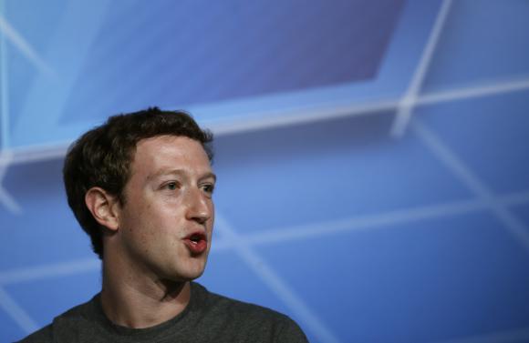 Facebook CEO Zuckerberg smiles in the stage before delivering a keynote speech during the Mobile World Congress in Barcelona