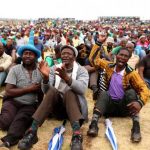Miners gather at Wonderkop stadium outside the Lonmin mine in Rustenburg, northwest of Johannesburg