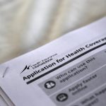 Applications are seen at a rally held by supporters of the Affordable Care Act in Jackson, Mississippi