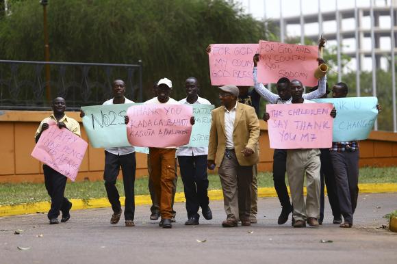 Supporters celebrate after Uganda's President Museveni signed a law imposing harsh penalties for homosexuality in Kampala