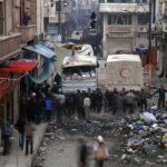Syrian Arab Red Crescent trucks stand in the besieged neighbourhoods of Homs to supply humanitarian aid
