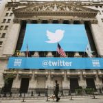 A sign displays the Twitter logo on the front of the New York Stock Exchange ahead of the company's IPO in New York