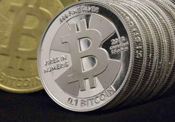 Some of Bitcoin enthusiast Mike Caldwell's coins are pictured at his office in this photo illustration in Sandy