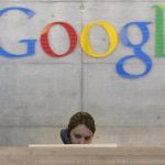 An employee answers phone calls at the switchboard of the Google office in Zurich