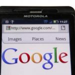 A Google homepage is displayed on a Motorola Droid phone in Washington