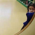 A girl opens the door of a teacher's staff room at the Emporium kindergarten in Koriyama, west of the tsunami-crippled Fukushima Daiichi nuclear power plant, Fukushima prefecture