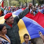Man dressed as late Venezuelan President Hugo Chavez waves during the Carnival festival in Caracas