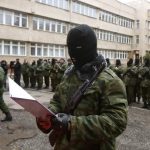 Member of a pro-Russian self defence unit takes an oath to Crimea government in Simferopol