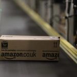 A parcel travels along a conveyer belt at Amazon's new distribution center in Brieselang