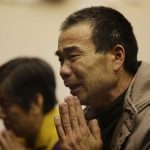 A relative of a passenger onboard Malaysia Airlines Flight MH370 cries prays at a praying room in Beijing