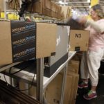 Worker prepares an item for delivery at Amazon's distribution center in Phoenix