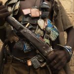 An anti-balaka militiaman poses for photograph on outskirts of capital Bangui