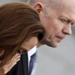 U.S. actress Angelina Jolie reacts with Britain's Foreign Secretary William Hague after paying respects to female victims and laying a wreath in front of the Srebrenica Genocide Memorial in Potocari
