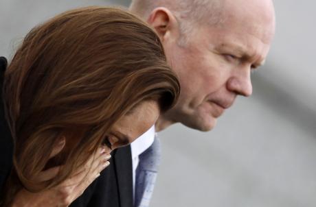 U.S. actress Angelina Jolie reacts with Britain's Foreign Secretary William Hague after paying respects to female victims and laying a wreath in front of the Srebrenica Genocide Memorial in Potocari
