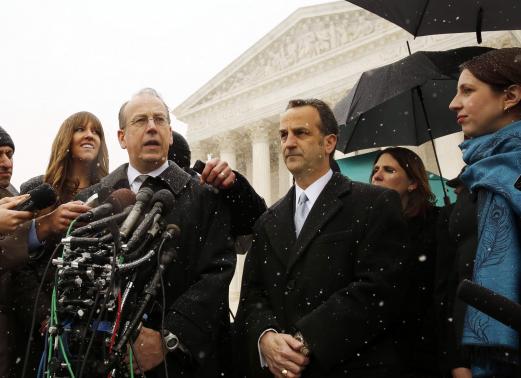 Attorney Paul Clement speaks to the press next to attorney Dave Cortman on the steps of the Supreme Court in Washington