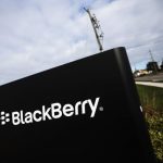 A man walks by a Blackberry sign at the Blackberry campus in Waterloo