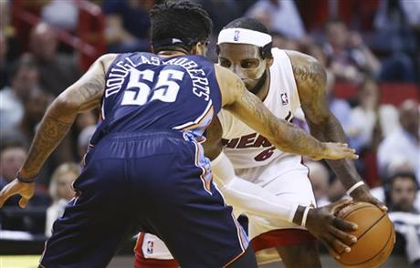 Charlotte Bobcats' Chris Douglas-Robert (55) tries to block Miami Heat's LeBron James (6)