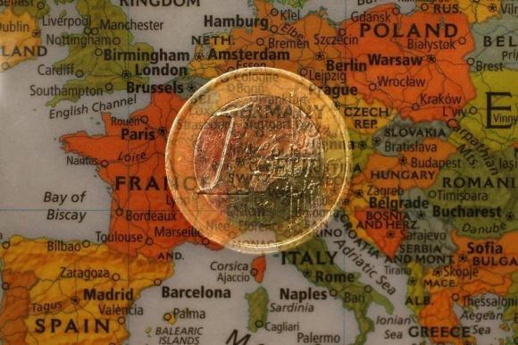 A picture illustration taken with the multiple exposure function of the camera shows a one Euro coin and a map of Europe