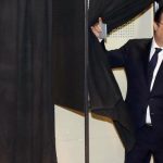 French President Francois Hollande leaves a polling booth before casting his ballot for the first round in the French mayoral elections at a polling station in Tulle