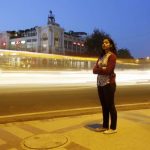 Inayat Naomi Ramdas, 21, poses for a photograph at a busy traffic intersection in New Delhi