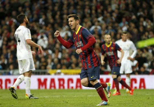 Barcelona's Lionel Messi celebrates after scoring a penalty against Real Madrid during La Liga's second 'classic' soccer match of the season at Santiago Bernabeu stadium in Madrid