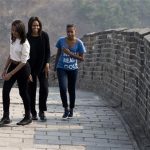 Michelle Obama walks with her daughters Malia, left, and Sasha, right