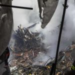 New York City emergency responders search through the rubble at the site of a building explosion in the Harlem section of New York